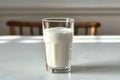 Side view elegance Glass of milk on white table, gray background