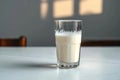 Side view elegance Glass of milk on white table, gray background