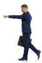 side view of elegant fashion guy pointing fingers and smiling Royalty Free Stock Photo