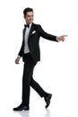 Side view of elegant groom walking and pointing finger Royalty Free Stock Photo