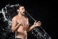 side view of emotional young man swilled with water