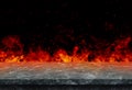 Empty marble stone table top with orange fire or flame and sparkles in dark room. Royalty Free Stock Photo