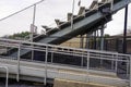 Side view of empty outdoor High School stadium bleachers seats steps Royalty Free Stock Photo