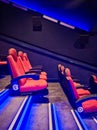 Side View of Empty Red Cinema Seats Through Staircase with Blue Lighting Royalty Free Stock Photo