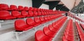 Side view of empty red plastic seats row at football sport stadium. stadium seats background. Royalty Free Stock Photo