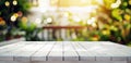 Side view of an empty white wooden table top in a garden. Image with a gentle blurred soft light background of garden foilage