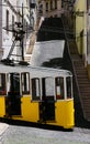 Side view of empty yellow Bica Funicular tram in Lisbon, Portugal