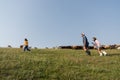 side view of family herding cattle