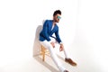 Side view of a fashion man sitting in studio Royalty Free Stock Photo