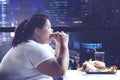 Fat woman having dinner in the restaurant Royalty Free Stock Photo