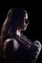 Side view of female fighter holding chain around neck Royalty Free Stock Photo