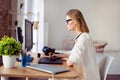 Side view of female graphic designer working with interactive pen display, digital drawing tablet and pen on a computer Royalty Free Stock Photo