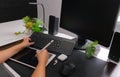 Side view of female graphic designer working on tablet and computer at office desk, working at home Royalty Free Stock Photo