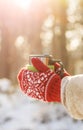 Side view of female hand holding hot cup of coffee in winter Royalty Free Stock Photo