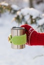 Side view of female hand holding hot cup of coffee in winter Royalty Free Stock Photo