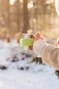 Side view of female hand holding hot cup of coffee in winter Royalty Free Stock Photo