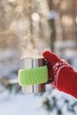 Side view of female hand holding hot cup of coffee in winter Royalty Free Stock Photo