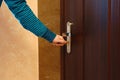 Side view female hand key to insert in door lock Royalty Free Stock Photo