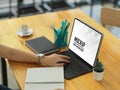 Side view female hand working digital tablet and stationery on wooden table Royalty Free Stock Photo