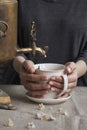 Side view of female hands pouring cup of tea from vintage samovar and jar of homemade jam, tea party concept Royalty Free Stock Photo