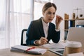 side view of female lawyer doing paperwork at workplace with laptop