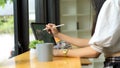 Side view of female office worker working with digital tablet on the bar in cafe Royalty Free Stock Photo