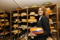 Side view of female salesperson holding cheese in store