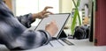 Female searching information for travel insurance on mock-up tablet on worktable