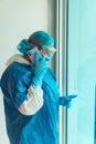 Side view of a female specialist in protective gown with mas Royalty Free Stock Photo