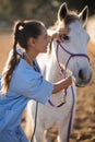 Side view of female vet checking horse Royalty Free Stock Photo