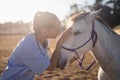 side view of female vet stroking horse Royalty Free Stock Photo