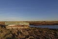 Side view of a Fishing boat wreck on the Grassy banks of a small Estuary