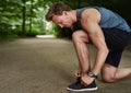 Side View of a Fit Young Man Tying Shoelace