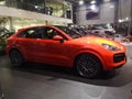 Side view of the five-seat sports cross-over Porsche Kayenne orange in the motor show on February 05, 2020 in Russia, Kazan,