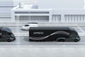 Side view of a fleet of black self-driving electric semi trucks driving on highway