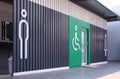 Male, disabled wheelchair and female signs in public restroom area Royalty Free Stock Photo