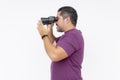 Side view of a focused man holding binoculars, searching or observing, isolated on a white background