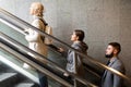 Side view of people moving up on escalator Royalty Free Stock Photo