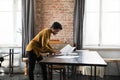 Focused young African American businesswoman working standing at table. Royalty Free Stock Photo