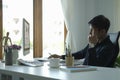 Side view focused young businessman analysing financial data on laptop computer