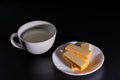 Side view four wafer in white plate with cup of milk on black background with copy space Royalty Free Stock Photo