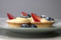 French dessert. tart with custard, fresh strawberries, blueberries and icing sugar Royalty Free Stock Photo