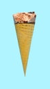 side view of fresh chocolate flavor ice cream cone with a bite on a blue background Royalty Free Stock Photo