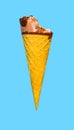 fresh chocolate flavor ice cream cone with a bite on a blue background Royalty Free Stock Photo