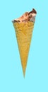 side view of fresh chocolate flavor ice cream cone with some bites on a blue background Royalty Free Stock Photo