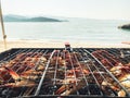 Side view fresh crabs cooked on bbq grill using coil with beach panorama in Oman. Gurman dish preparation Royalty Free Stock Photo