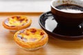 Fresh portuguese egg tarts with cup of coffee nearby Royalty Free Stock Photo