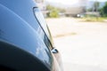 Side view of the front of the car revealing a slightly chromed headlight. Royalty Free Stock Photo