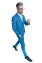 Sexy elegant businessman in suit holding hand in pocket and walking Royalty Free Stock Photo