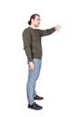 Side view full length  portrait of displeased young man showing thumb down, negative gesture and bad feedback, isolated on white Royalty Free Stock Photo